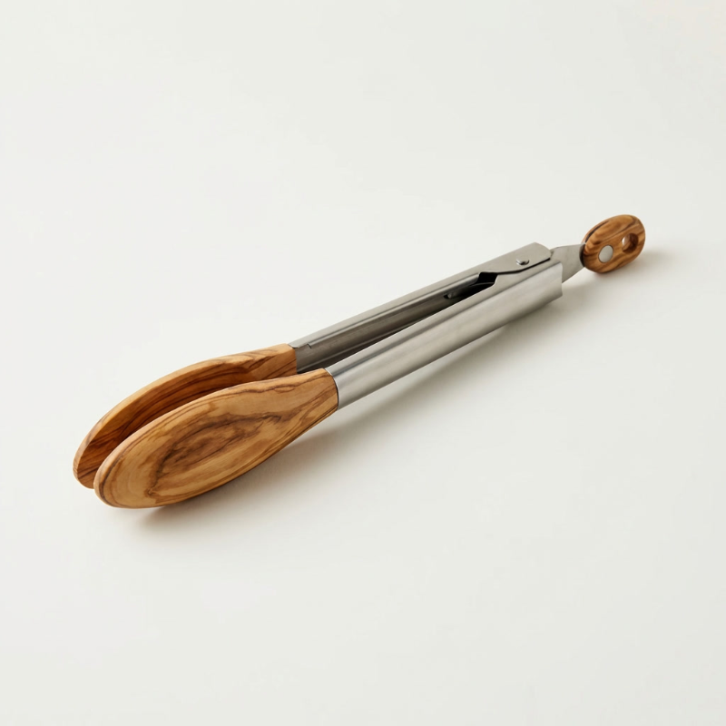Stainless steel and wood tongs on white background with wood detail