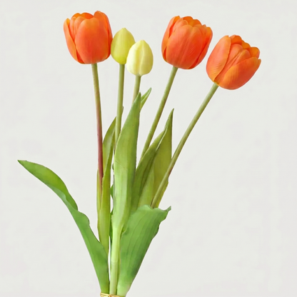 Bouquet of orange and yellow tulips on a light gray background