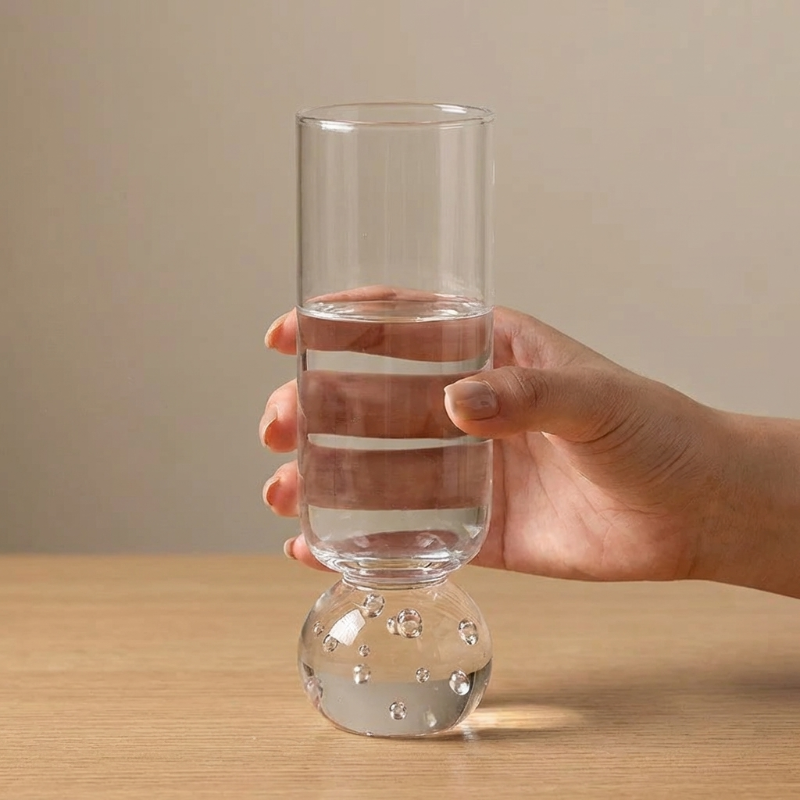 Orb base glass shown in hand on white background