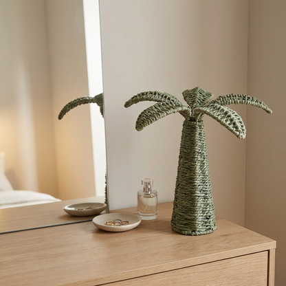 Decorative palm tree sculpture on a wooden surface with a neutral background