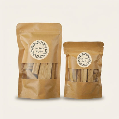 Two brown paper bags with clear windows containing Palo Santo sticks on a light beige background.