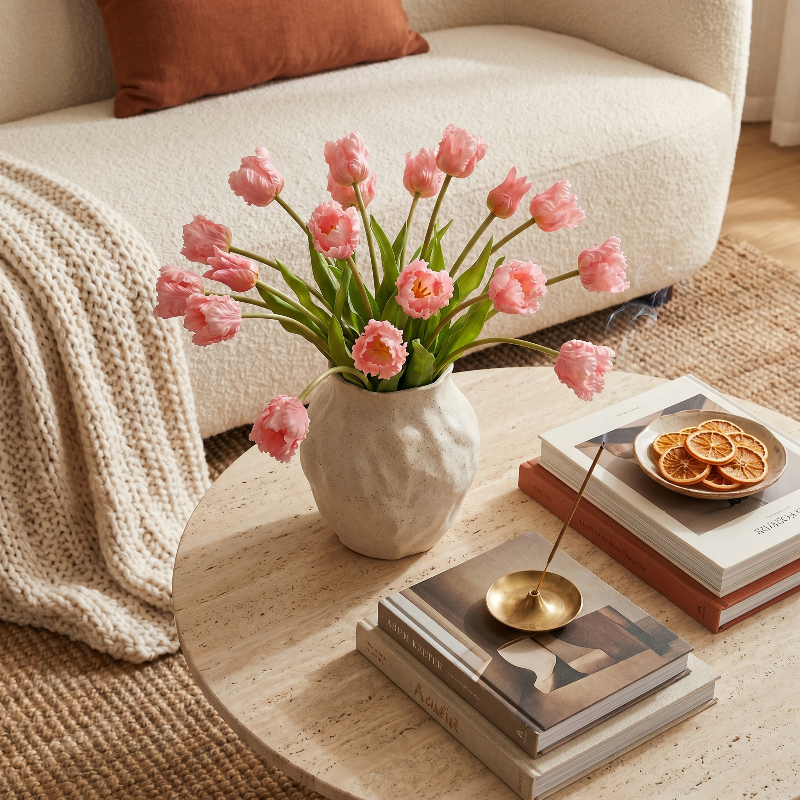 Parrot faux silicone tulips in soft pink bouquet in ceramic vase on coffee table
