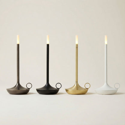 Four candle holders with lit candles on a neutral background