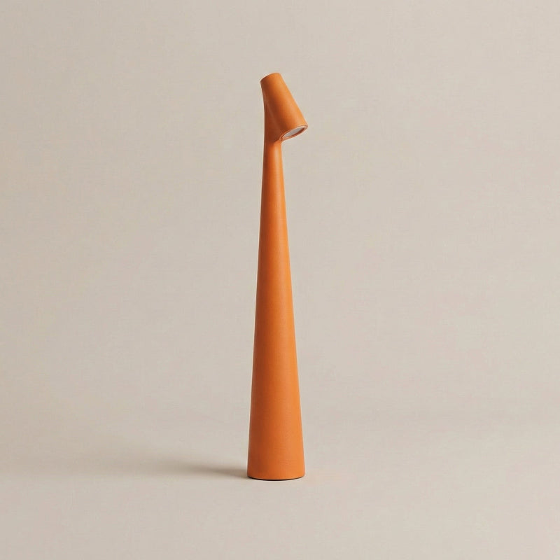 Tall, slender orange vase on a beige background