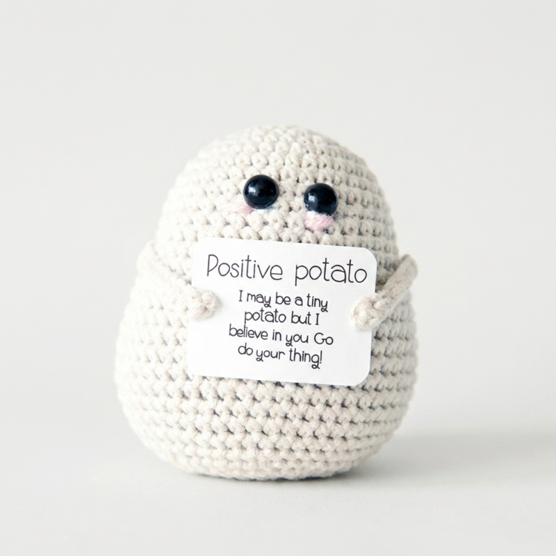 White positive potato crochet doll on white background
