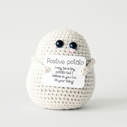 White positive potato crochet doll on white background