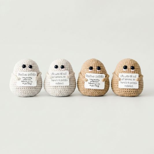 Set of positive potato crochet dolls on white background