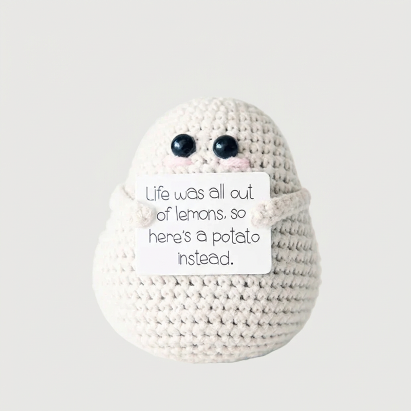 White positive potato crochet doll with handwritten encouragement sign