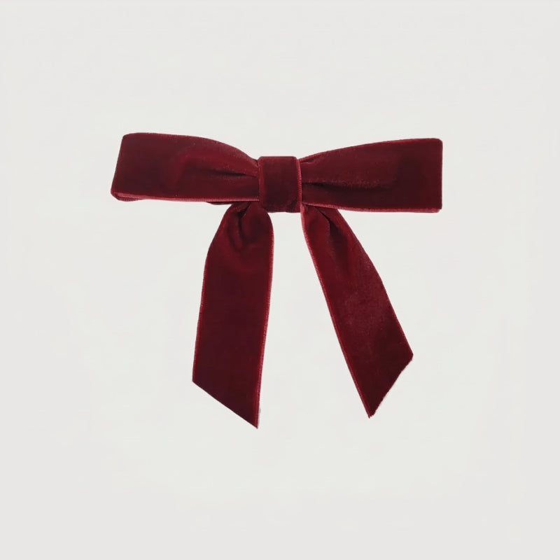 Burgundy velvet bow on white background