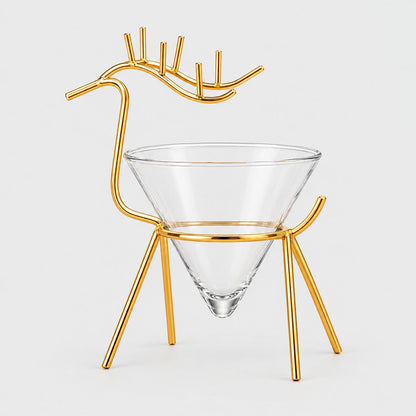 Gold metal reindeer stand with antlers holding an empty clear cone cocktail glass on a light grey background