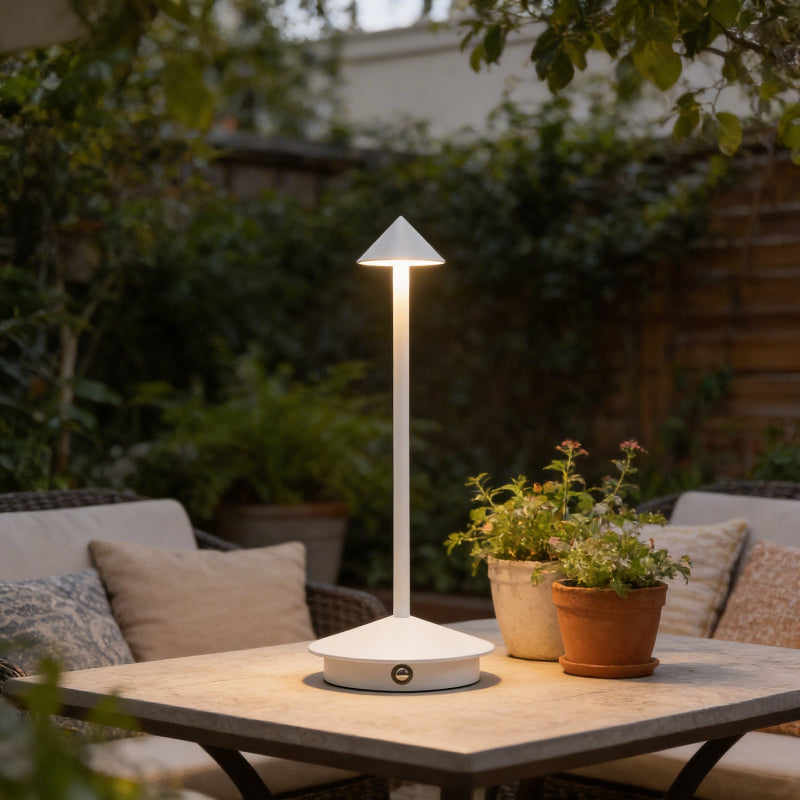Remi indoor outdoor table lamp on patio table with potted plants
