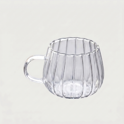 Ribbed glass mug on white background side view