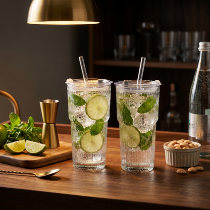 Ribbed glass tumblers with lime drinks on bar counter