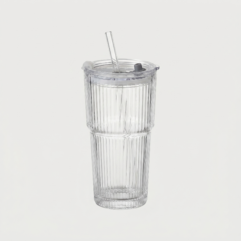 Ribbed glass tumbler on white background