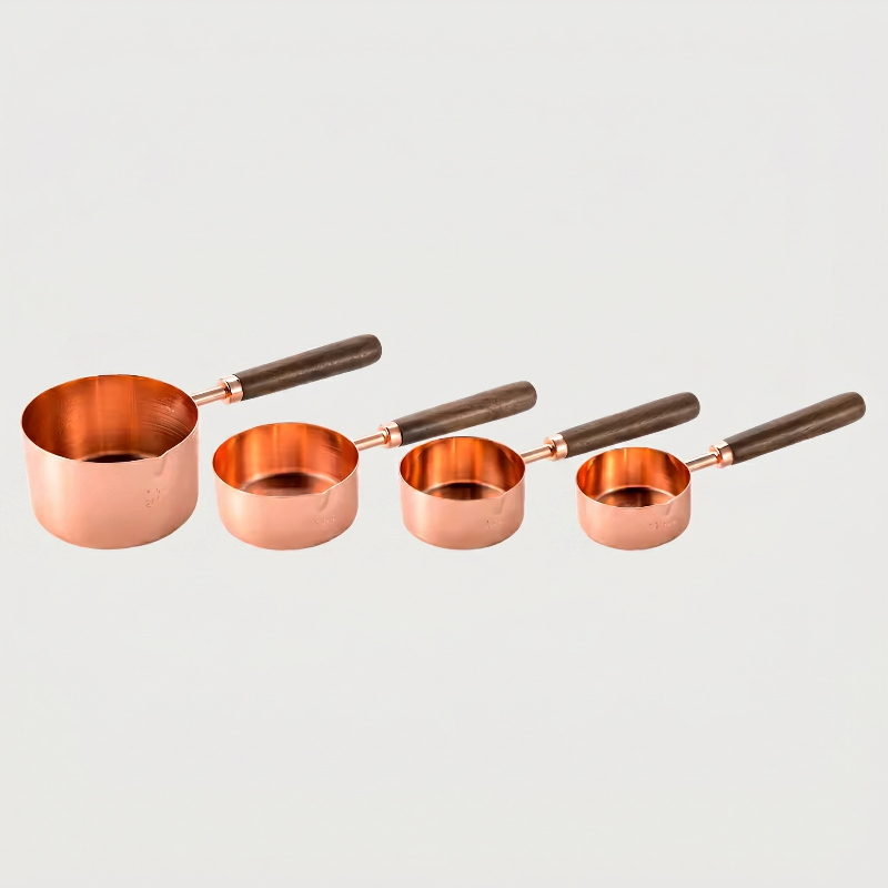 Copper measuring spoons set of 4 on white background