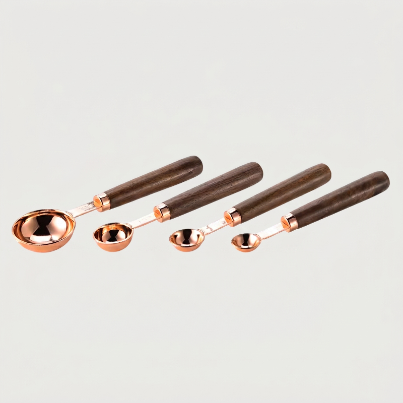 Rose gold measuring spoons set of 4 on white background