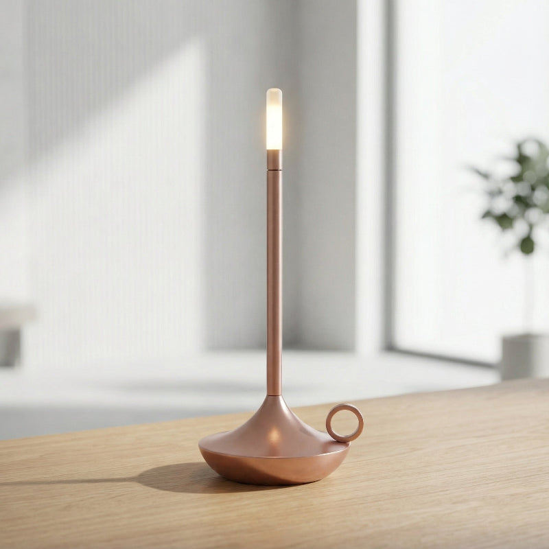 Modern table lamp with a warm glow on a wooden surface.