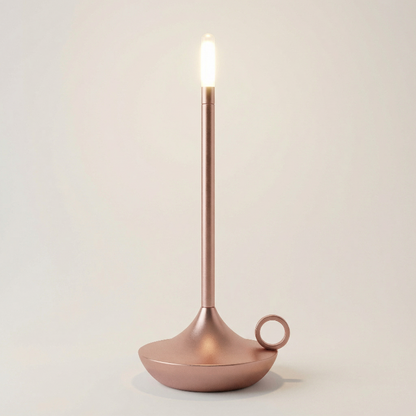Candle holder with a lit candle on a plain background
