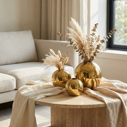Round gold vase on coffee table styled with gold accents