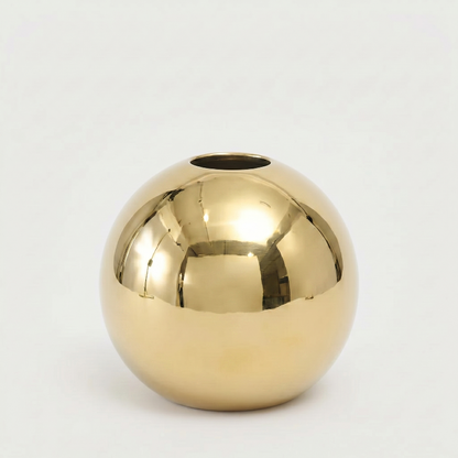Round gold vase on white background