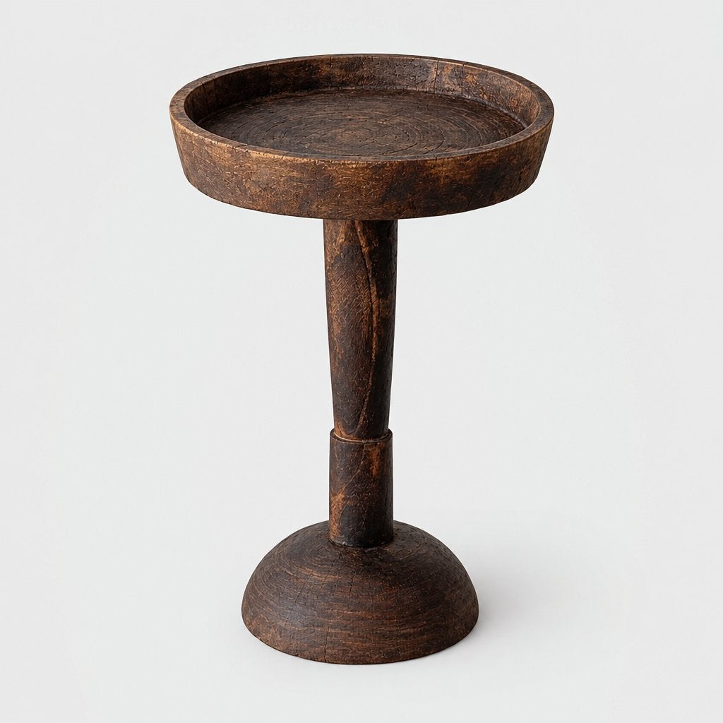 Large dark wood round pedestal side table with a shallow raised rim and a flared round base on a light grey background