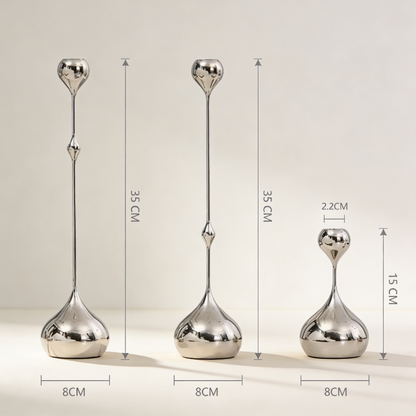 Three silver decorative vases with measurements on a beige background