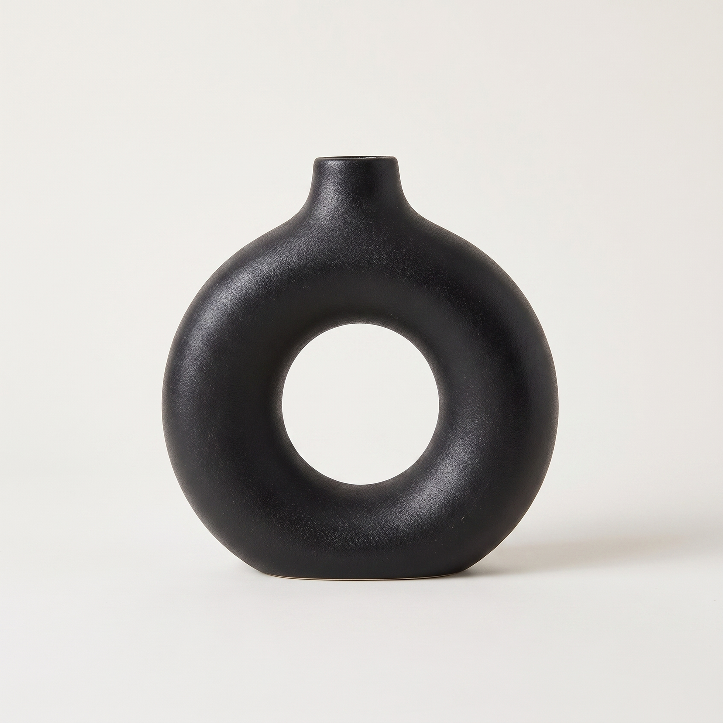 Black Sculptural Ring Ceramic Vase hero shot on a clean off-white studio background