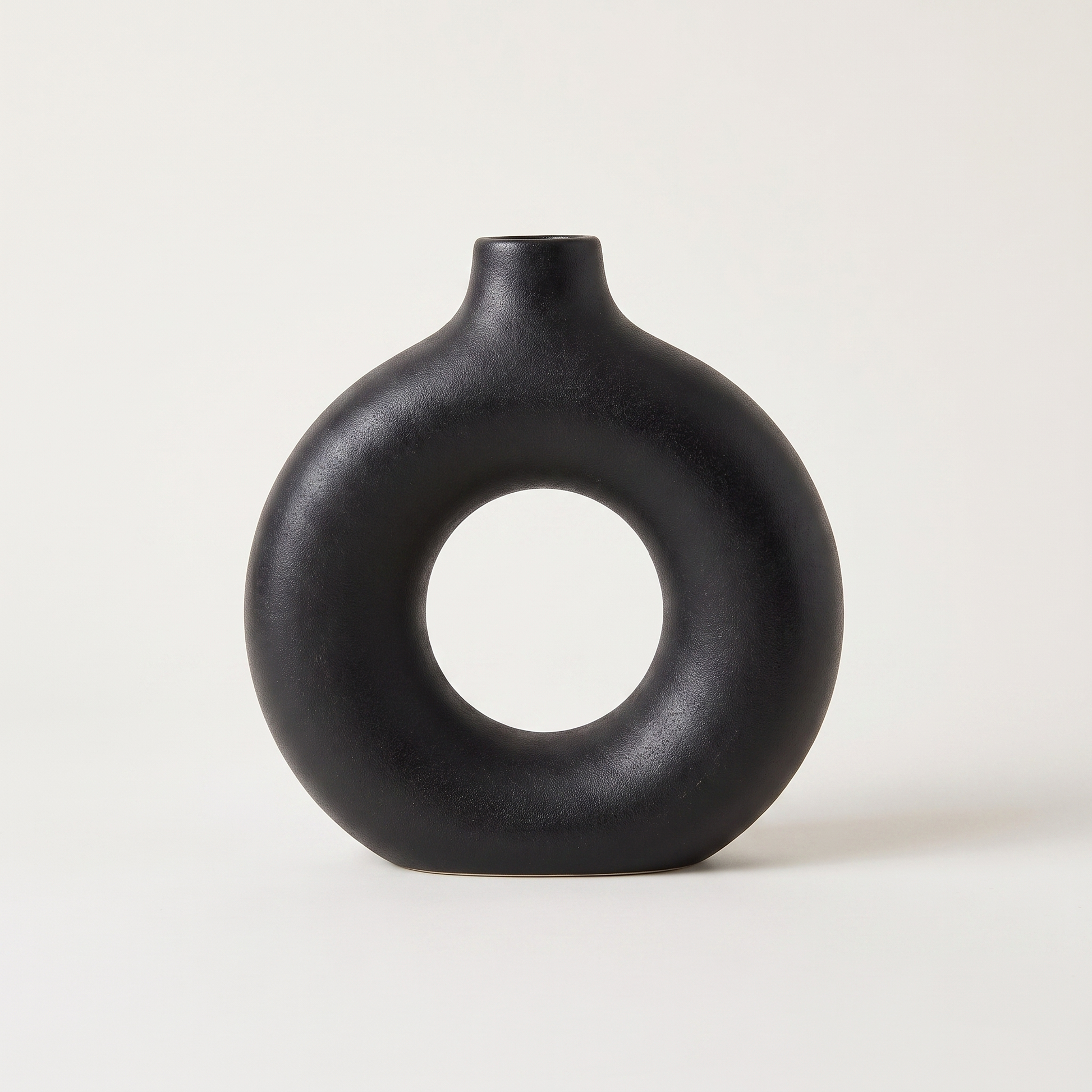 Black Sculptural Ring Ceramic Vase hero shot on a clean off-white studio background