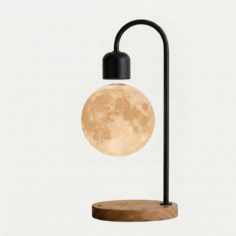 Selene floating moon lamp with wireless charging on dark wood base on white background
