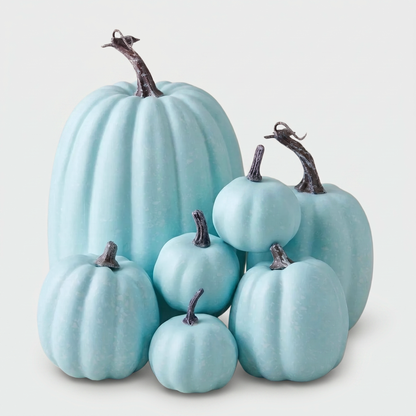 Set of seven pastel blue decorative pumpkins on a clean off-white background