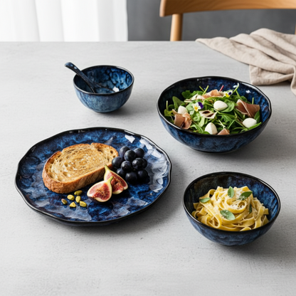 Set of blue ceramic dishes with food on a light gray surface