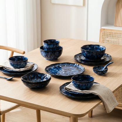 Set of blue ceramic dishes on a wooden table with a neutral background