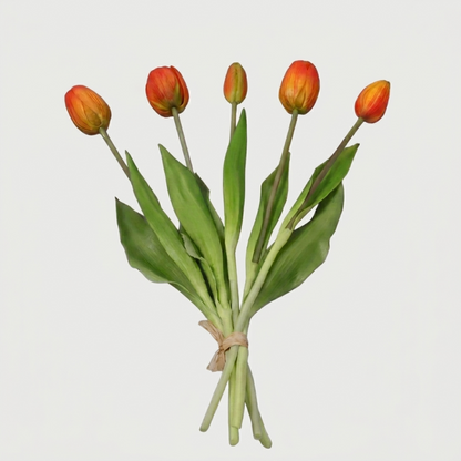 Faux silicone tulip stems in orange and yellow on white background
