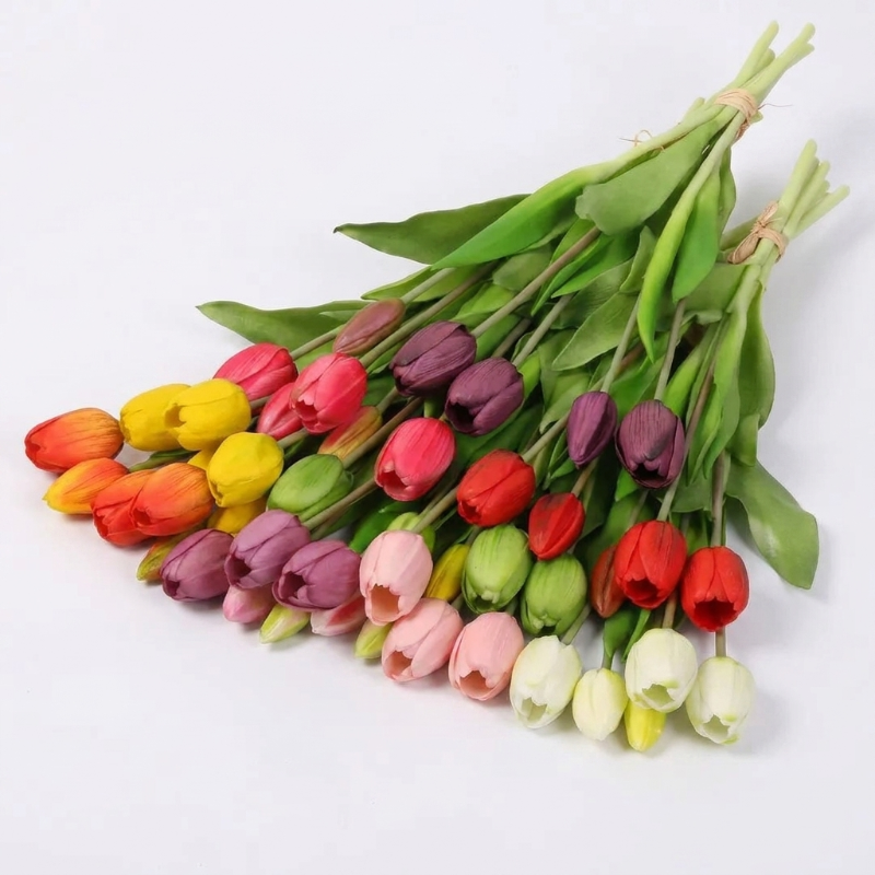 Faux silicone tulip stems in assorted colors on white background