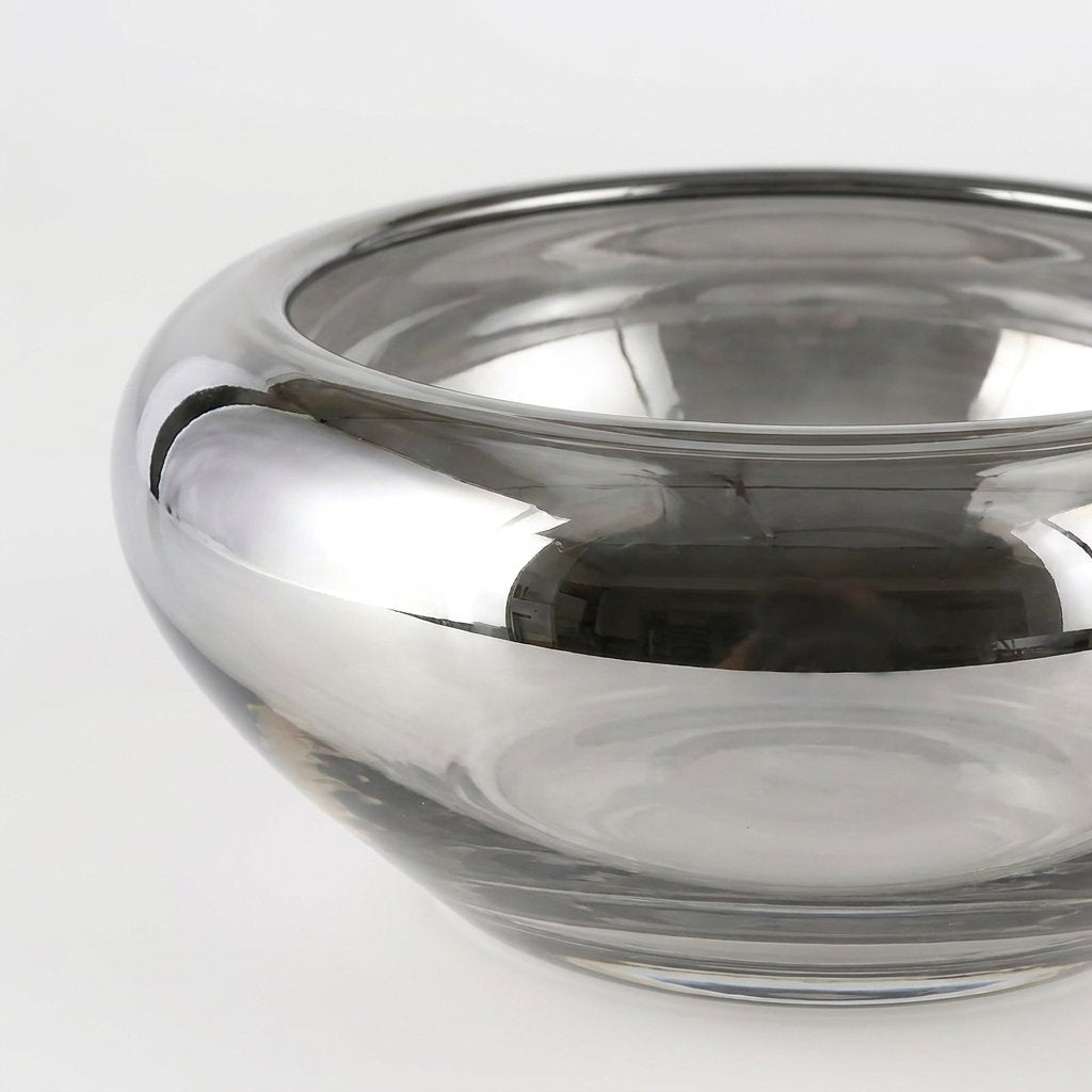 Close-up of the silver glass bowl's rim showing the mirrored finish and subtle handmade ripples in the glass