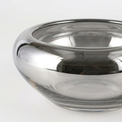 Close-up of the silver glass bowl's rim showing the mirrored finish and subtle handmade ripples in the glass