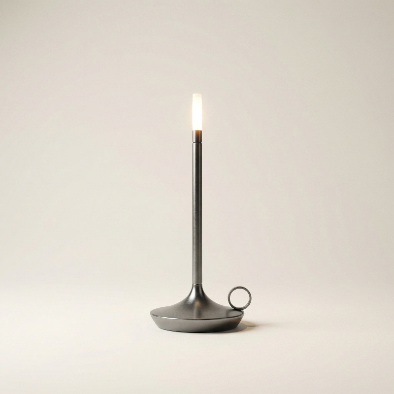 Black candle holder with a lit candle on a beige background