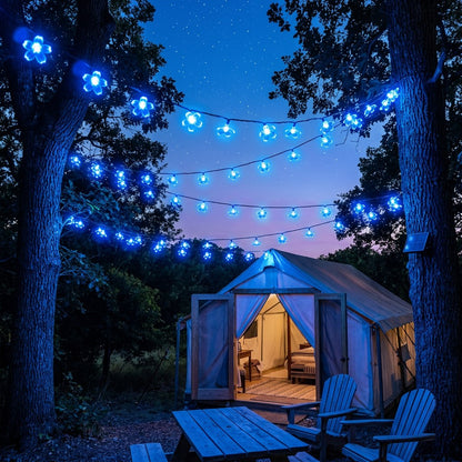 Blue solar blossom string lights strung over an outdoor tent at night, Kiyo Home