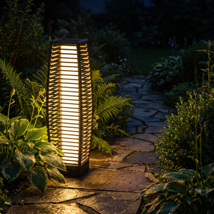 Modern outdoor solar floor lantern glowing along a garden pathway at night