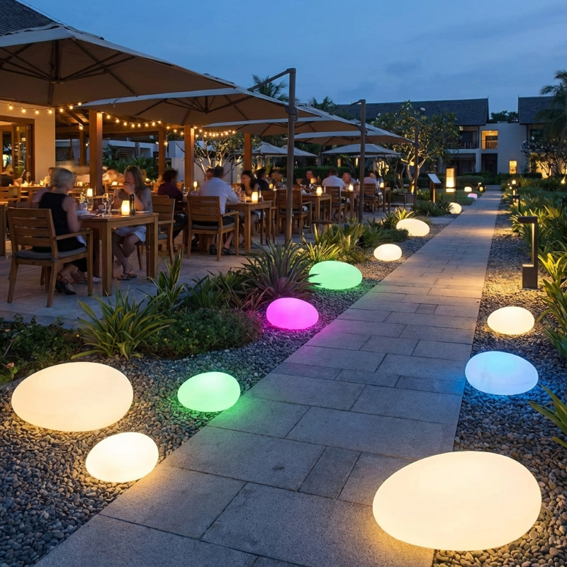 Outdoor dining area with colorful illuminated lights on a pathway