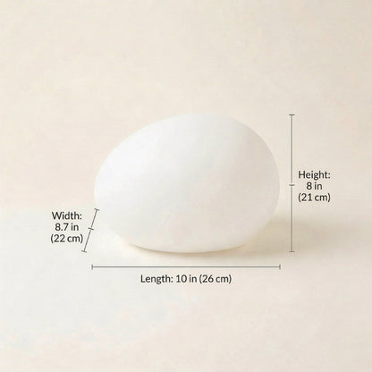White spherical object with measurements on a beige background