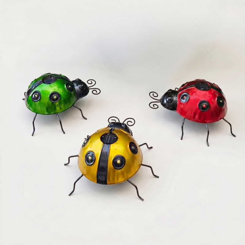 Solar metal ladybug garden lights in green, red, and yellow on white background