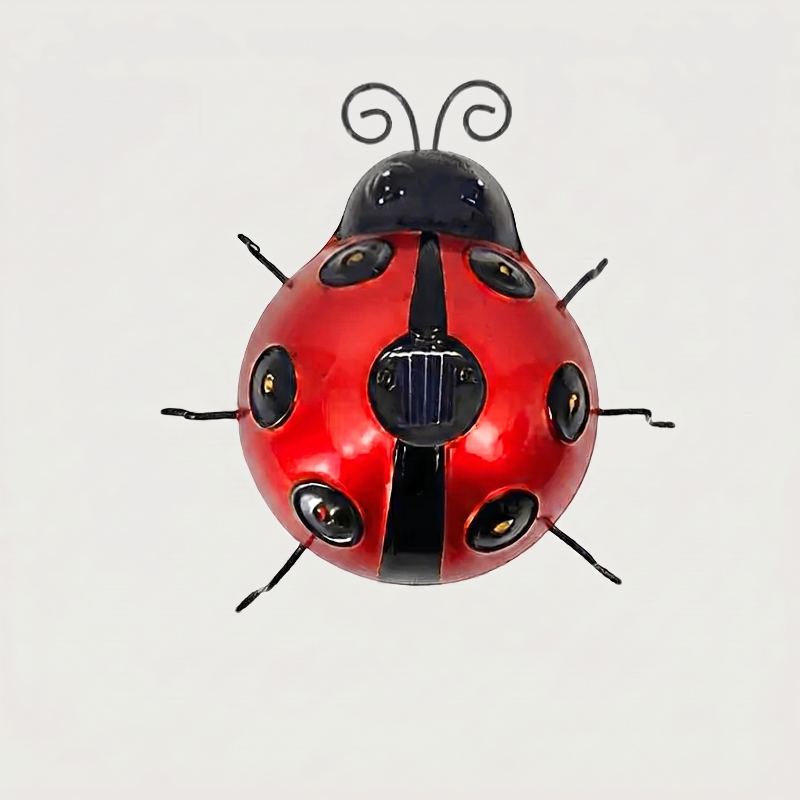 Red solar metal ladybug garden light on white background