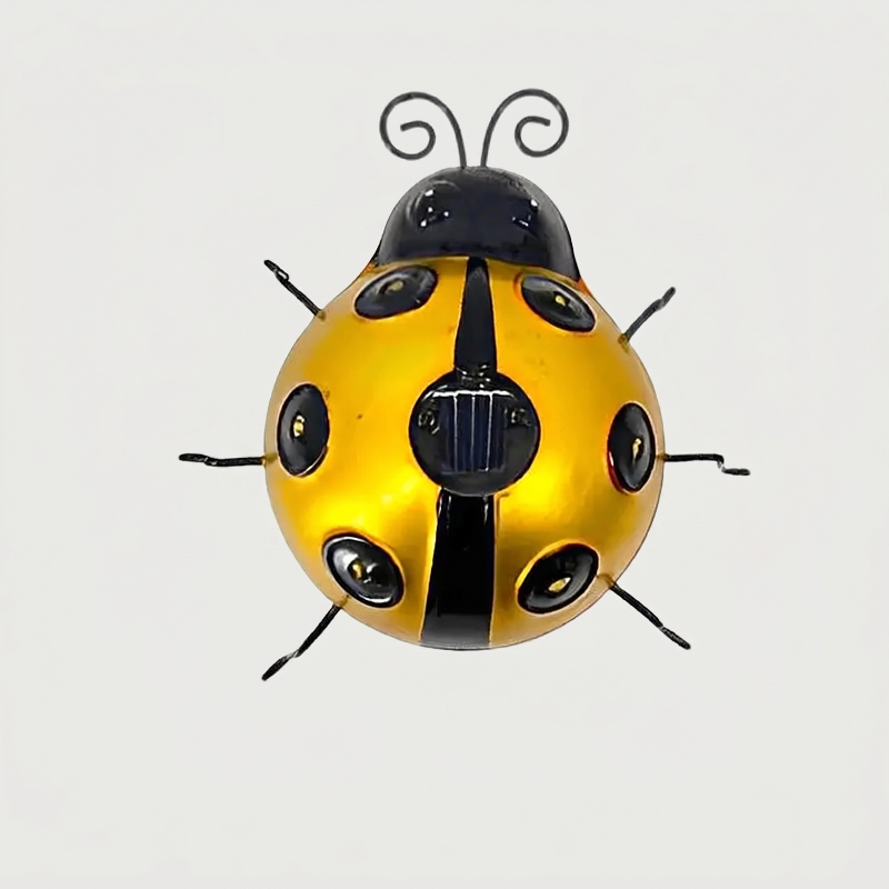 Yellow solar metal ladybug garden light on white background