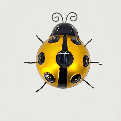Yellow solar metal ladybug garden light on white background