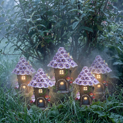 Solar mushroom garden lantern glowing among plants in misty garden