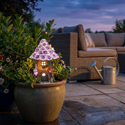 Solar mushroom garden lantern in planter on patio at twilight