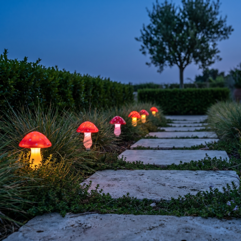 Solar mushroom accent lights lining garden path at night