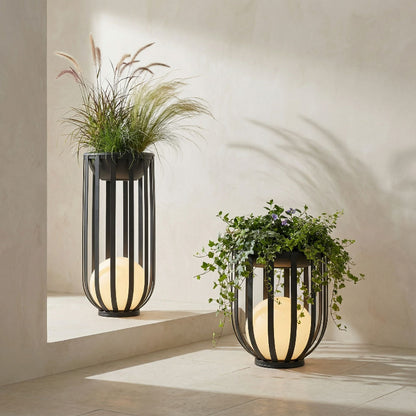 Two modern outdoor lamps with planters on a neutral background