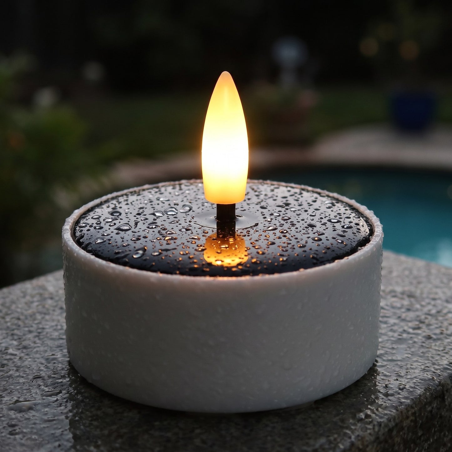 Close-up of a solar LED flameless tea light candle with a waterproof solar top and amber flame, Kiyo Home